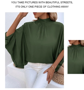 Detail of elegant dark green high-neck chiffon blouse with pleated batwing sleeves