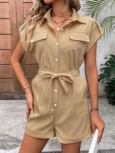 Detail of khaki romper with contrast buttons, drawstring waist, and utility pockets