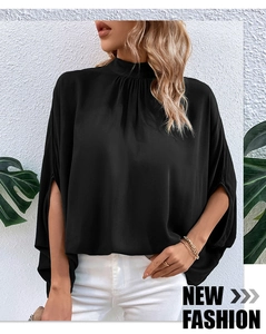 Detail of black high-neck blouse featuring pleated collar and side-slit cape sleeves