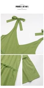 Detail of green cotton linen dress featuring lace-up shoulder straps and V-neckline