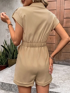 Back view of khaki short sleeve romper with elastic high waist and cuffed hem details