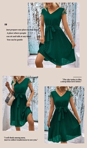 Detail of dark green pleated V-neck dress with lace trim and waist belt on a model