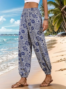 Detailed view of bohemian blue mandala print on high waist smocked beach trousers