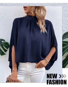 Detail of dark blue high-neck chiffon top with pleated collar and split batwing sleeves