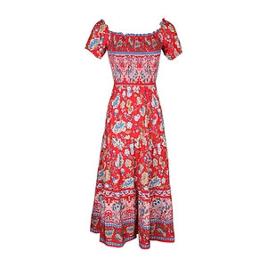 Detail of red Bohemian floral dress with smocked bodice and puff sleeves on white background