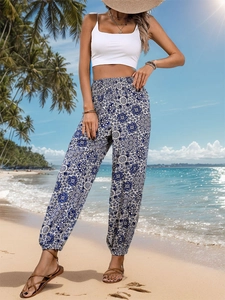 Detail of high waisted bohemian print trousers with elastic ankles and ethnic pattern