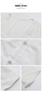 Close-up detail of white V-neck lace top with intricate cutout hollow patterns