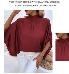 Detailed view of burgundy mock neck blouse with pleated collar and batwing sleeves