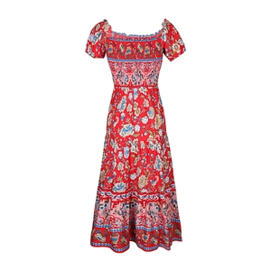 Detail of red floral bohemian maxi dress showing smocked bodice and tiered ruffled hem