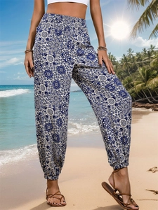 Detail of blue and white mandala print on high waist bohemian summer beach trousers