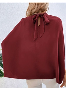 Detail of burgundy chiffon blouse featuring an elegant back tie-up bow design