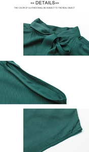 Detail view of dark green blouse showing bow tie neckline and fine stitching