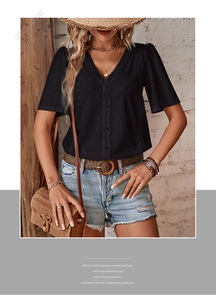 Detail of V-neckline featuring delicate lace trim and eyelet embroidery on black top