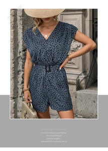 Detail of navy blue leopard print romper featuring a V-neck and waist belt with buckle