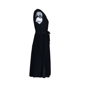 Detail view of black sleeveless pleated dress with lace trim and matching waist belt