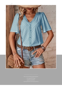 Detail view of V-neck light blue lace top with eyelet embroidery and button front
