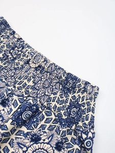 Detailed view of bohemian floral print pants with elastic smocked high waistband