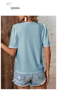 Detail view of light blue V-neck top with eyelet embroidery and hollow dot pattern