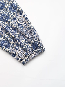 Detailed close-up of Bohemian blue and white mandala print fabric with elastic cuff detail