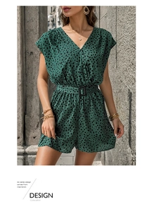 Detail view of green leopard print romper with deep V-neck and matching buckled waist belt