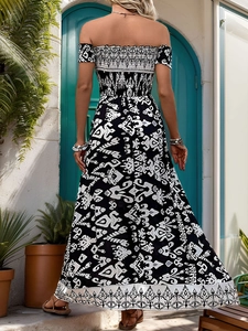 Back view of summer boho maxi dress with smocked bodice and tribal prints on a sunlit terrace