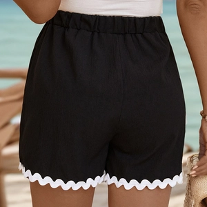 Women's black casual shorts with white wave lace trim and elastic waist for beach holidays
