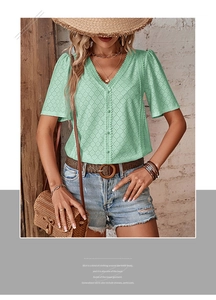 Close-up of mint green V-neck shirt with hollow embroidery and delicate lace trim detail