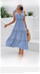 Detail of tiered light blue summer dress with ruffled waist and delicate shoulder ties
