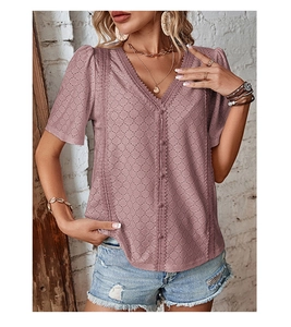 Detail of V-neck dusty rose blouse with eyelet embroidery and single-breasted buttons