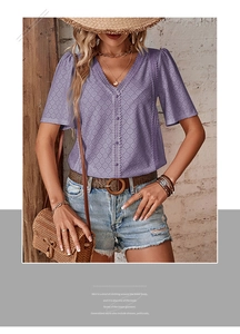 Close-up of purple V-neck eyelet lace blouse with geometric embroidery and buttons