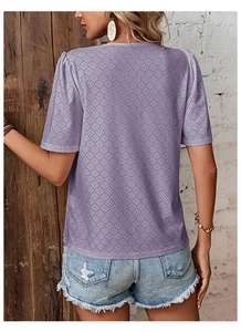 Detail view of light purple short sleeve top featuring intricate eyelet hollow textures