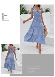 Detail of light blue tiered maxi dress with backless tie-up design and ruffled skirt