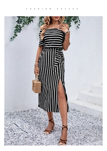 Detail of off-shoulder striped summer dress featuring a waist bow and high side slit design