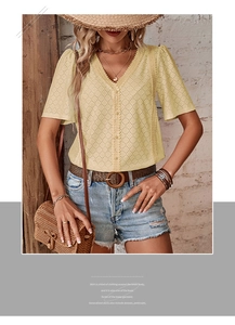 Close-up of the V-neckline and hollow-out eyelet embroidery on the yellow short-sleeved blouse