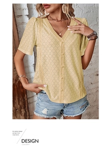 Detail of V-neck white lace short sleeve shirt with intricate hollow embroidery texture
