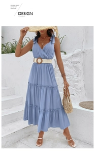 Detail of light blue V-neck tiered dress with woven straw belt and wooden buckle