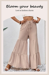 Detail view of high waist apricot tiered palazzo pants with elastic drawstring waist