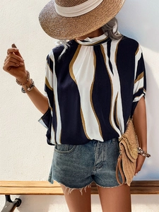 Detail of artistic flowing abstract print on summer shirt with high collar and loose fit