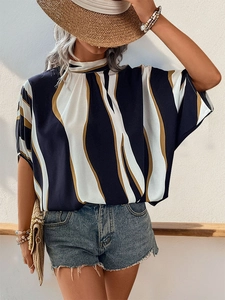Detail of navy and beige wavy print fabric on a loose batwing sleeve summer blouse