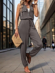 Detail of grey sleeveless cargo jumpsuit featuring zipper front and drawstring waist