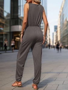 Rear view detail of a dark grey sleeveless jumpsuit with elastic waist and tapered cuffs