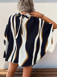 Detail of batwing sleeve print shirt with black and ginger wavy geometric pattern and bow