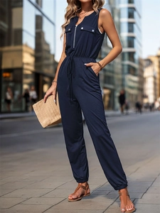 Detail of navy sleeveless jumpsuit with zipper v-neck, drawstring waist and cargo pockets