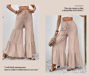 Detailed view of beige high waist tiered wide leg pants with waffle texture and drawstring