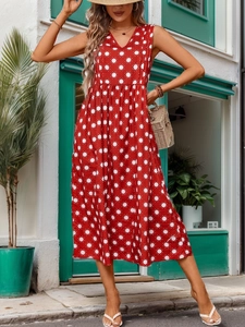 Detail of red sleeveless V-neck dress with white star print and high waist line