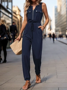 Close-up of navy blue sleeveless jumpsuit featuring a metal zipper and drawstring waist