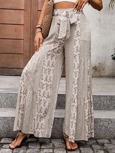 Bohemian high-waist tiered wide-leg trousers with floral prints and tie-belt for vacation