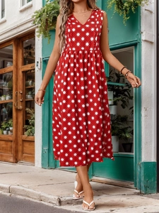 Detail of red sleeveless V-neck A-line dress featuring white sunburst print patterns