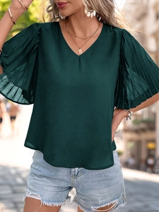 Detail of dark green V-neck top showing pleated ruffle sleeves and lightweight fabric