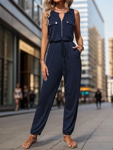 Detail of dark blue sleeveless jumpsuit with silver front zipper and drawstring waist